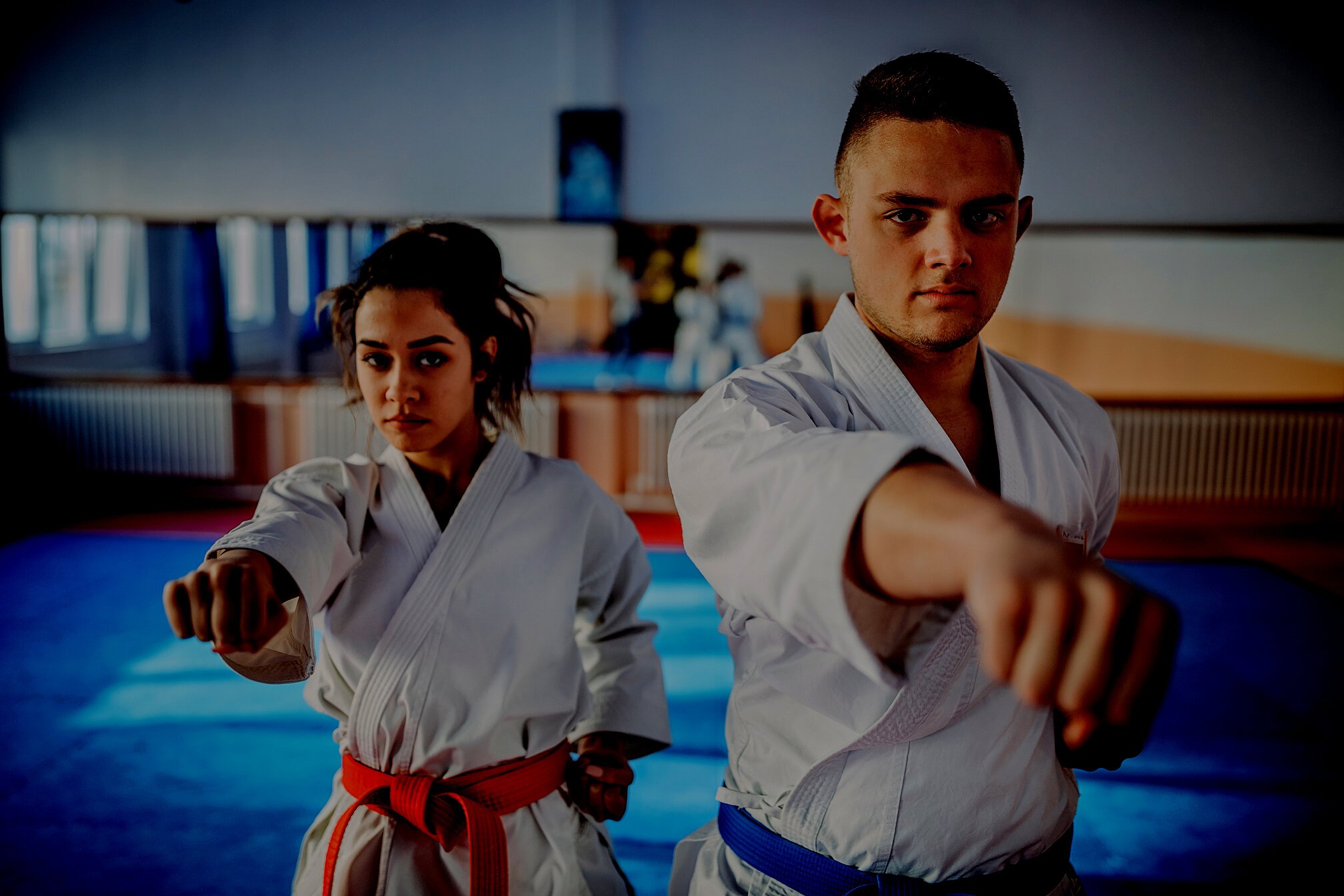 Karate students training karate together indoors